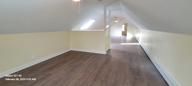 additional living space with vaulted ceiling, dark hardwood / wood-style floors, and ceiling fan