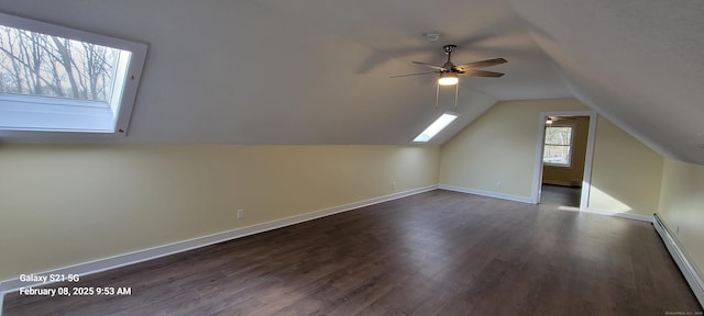 bonus room with a baseboard radiator, dark wood-type flooring, vaulted ceiling, and ceiling fan