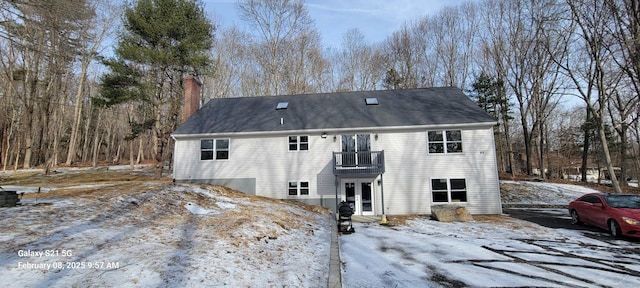 view of front of property featuring french doors and a balcony