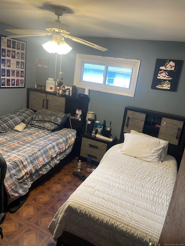 bedroom featuring ceiling fan and dark parquet flooring