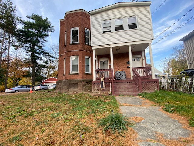 view of front of property with covered porch and a front lawn