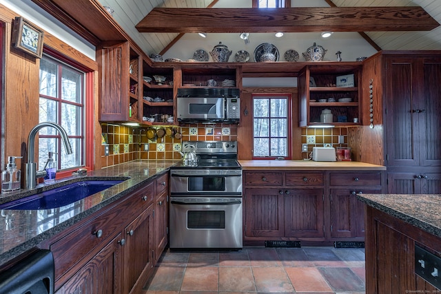 kitchen featuring sink, appliances with stainless steel finishes, dark stone countertops, backsplash, and vaulted ceiling with beams