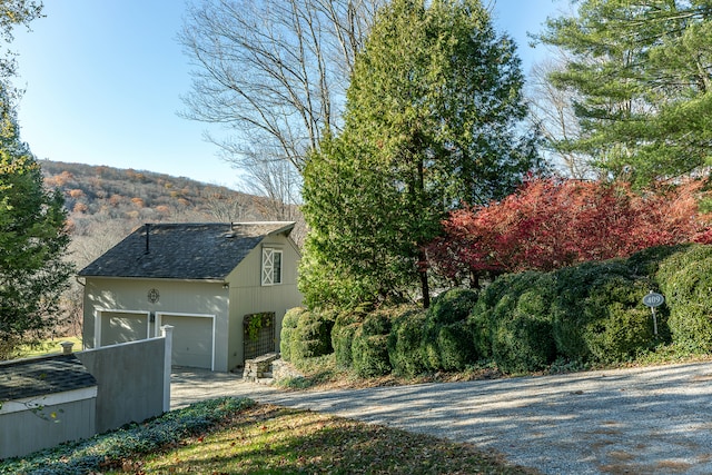 view of home's exterior featuring a mountain view and a garage