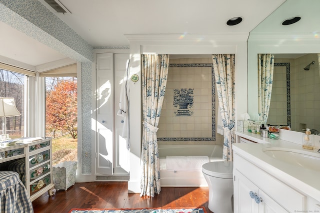 bathroom with wood-type flooring, vanity, and toilet