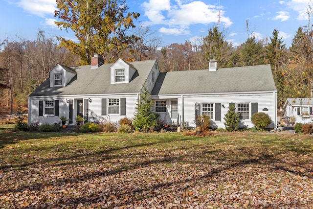 cape cod home with a front lawn