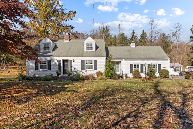 new england style home featuring a front yard