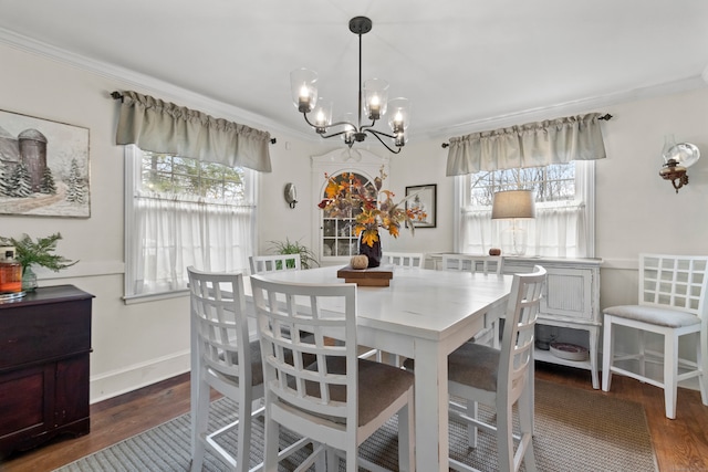 dining area with ornamental molding, a healthy amount of sunlight, and dark hardwood / wood-style floors