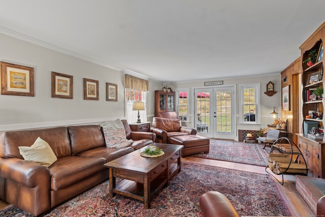 living room featuring hardwood / wood-style floors, french doors, and crown molding