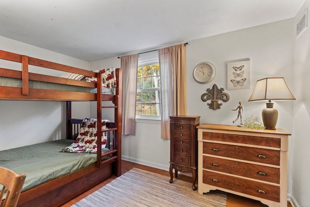 bedroom with hardwood / wood-style flooring