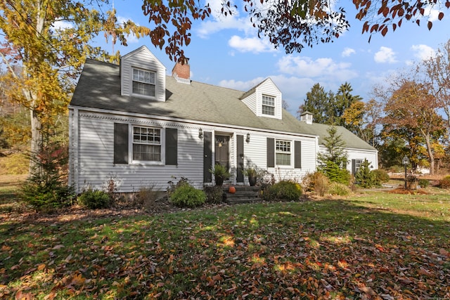 cape cod house featuring a front yard