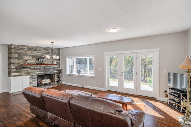 living room featuring a fireplace, hardwood / wood-style floors, and french doors