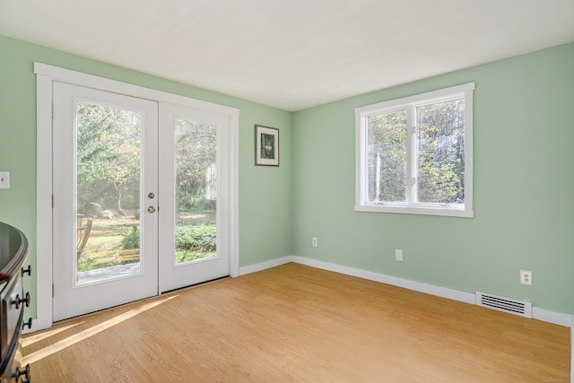 entryway with light wood-type flooring and french doors