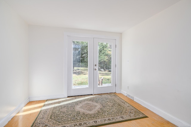 doorway with hardwood / wood-style flooring