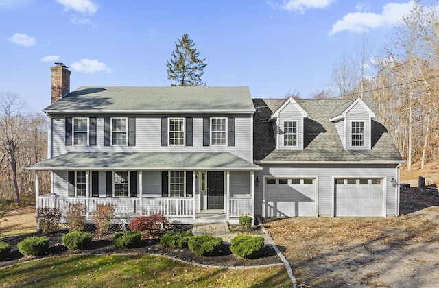 view of front of property featuring covered porch and a garage