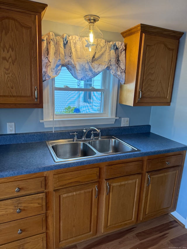 kitchen with sink, dark hardwood / wood-style floors, and hanging light fixtures