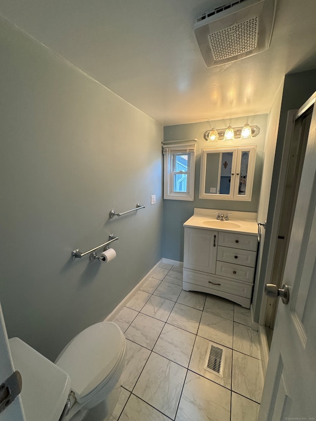 bathroom featuring toilet and vanity