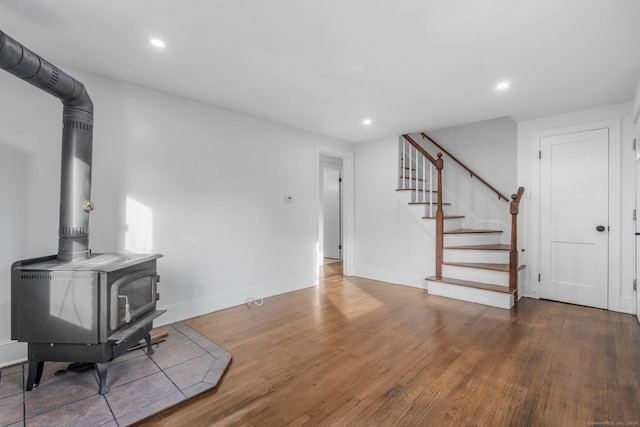 living room featuring a wood stove and hardwood / wood-style flooring