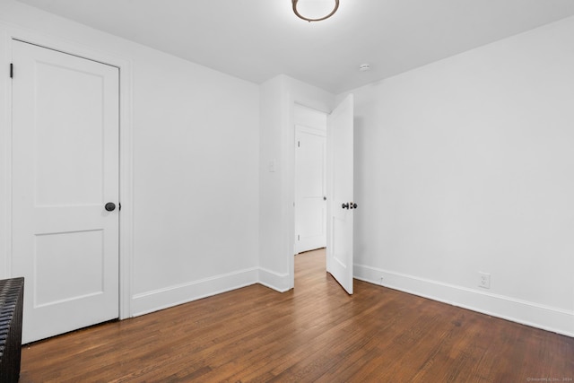 unfurnished bedroom featuring dark hardwood / wood-style flooring