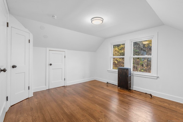 bonus room featuring radiator, lofted ceiling, and hardwood / wood-style flooring