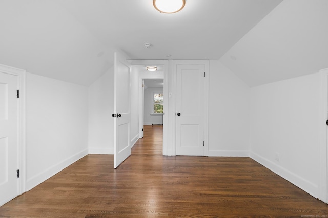 bonus room with dark wood-type flooring and lofted ceiling