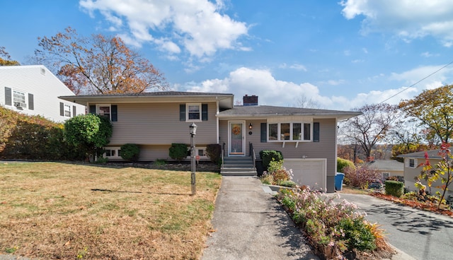 view of front facade with a front yard and a garage