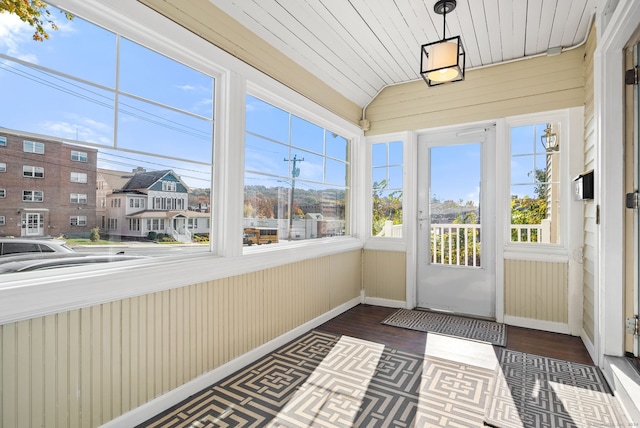 unfurnished sunroom with lofted ceiling