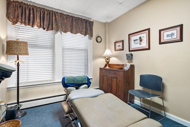 living area with a baseboard heating unit and carpet floors