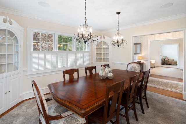 dining space with a notable chandelier, wood-type flooring, and crown molding