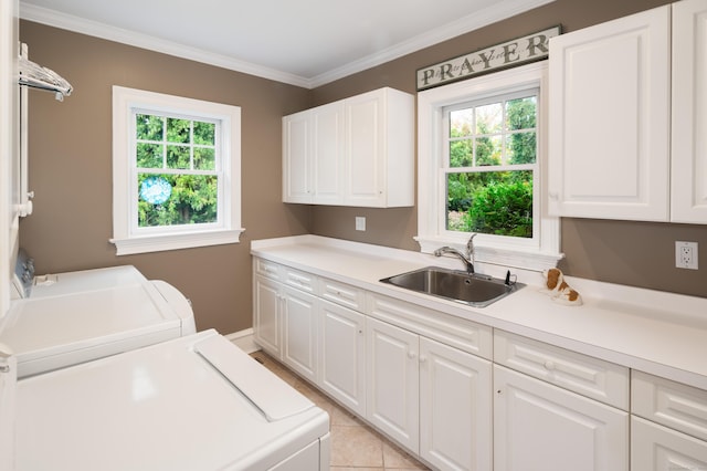 laundry area featuring a healthy amount of sunlight, cabinets, sink, and washing machine and clothes dryer