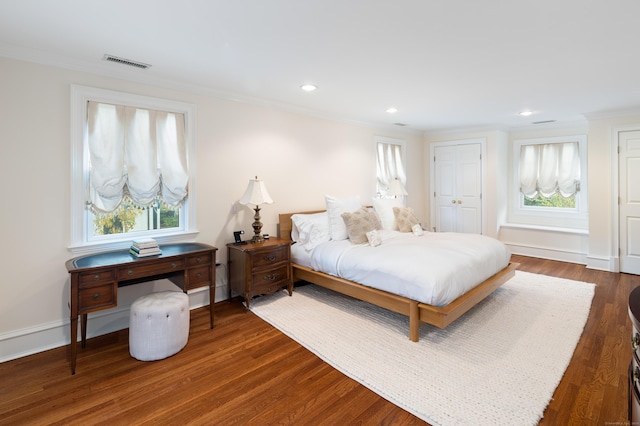 bedroom with crown molding and dark hardwood / wood-style flooring