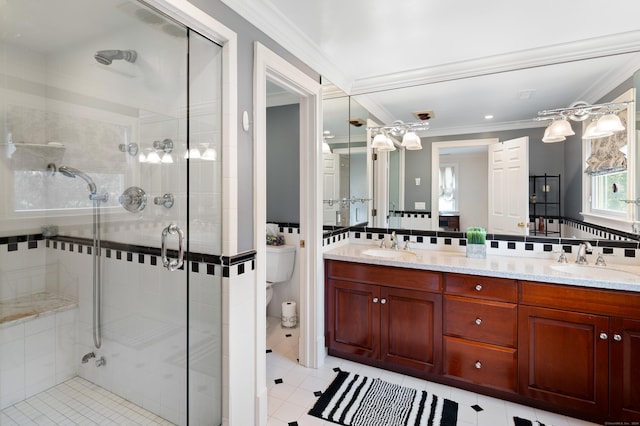 bathroom featuring vanity, toilet, crown molding, and walk in shower