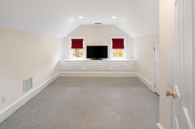 bonus room featuring light colored carpet and lofted ceiling