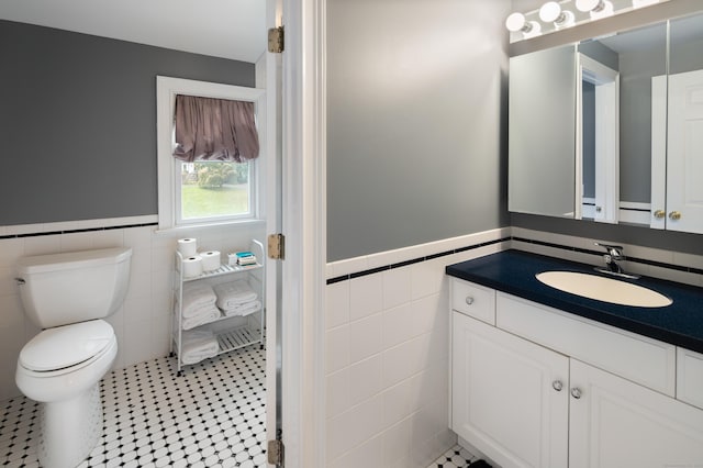 bathroom featuring tile patterned flooring, tile walls, and toilet