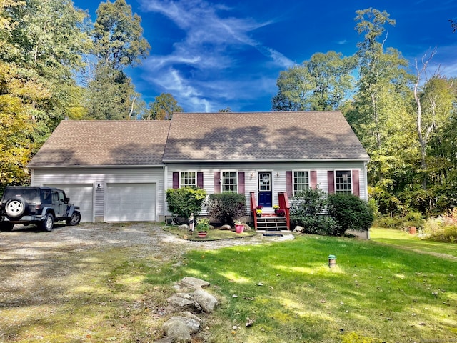 view of front of property with a front yard and a garage