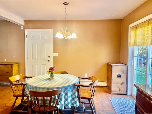 dining space with baseboard heating, beam ceiling, a notable chandelier, and light wood-type flooring