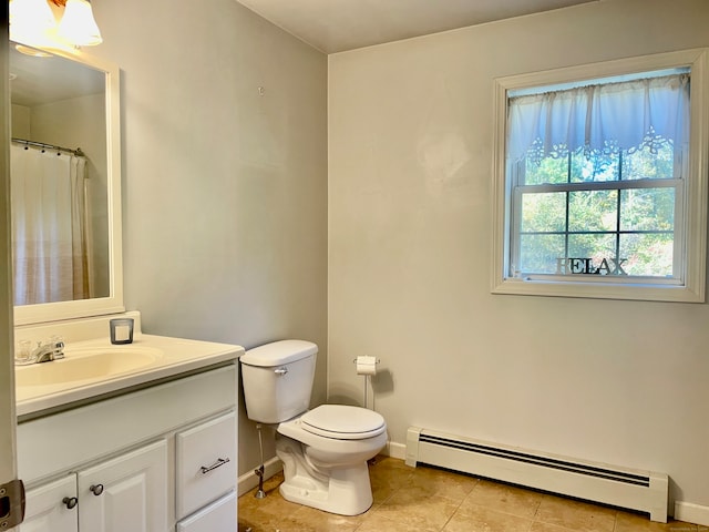 bathroom with vanity, toilet, tile patterned floors, and baseboard heating