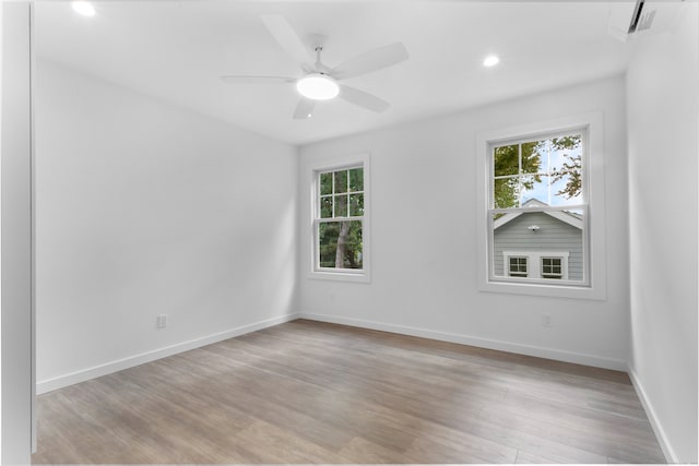 empty room with light wood-type flooring, plenty of natural light, and ceiling fan