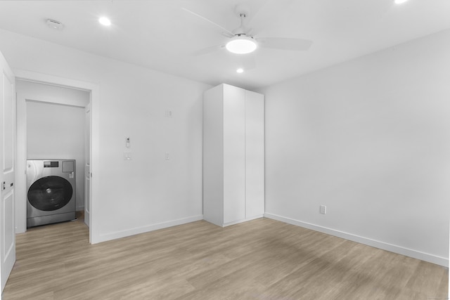 laundry room with ceiling fan, light hardwood / wood-style flooring, and washer / dryer