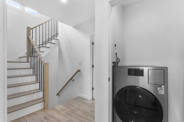 laundry area featuring light hardwood / wood-style floors and washer / clothes dryer