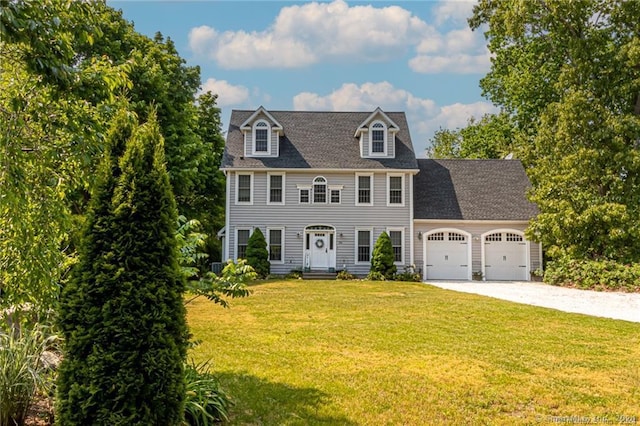 colonial inspired home featuring a front yard and a garage