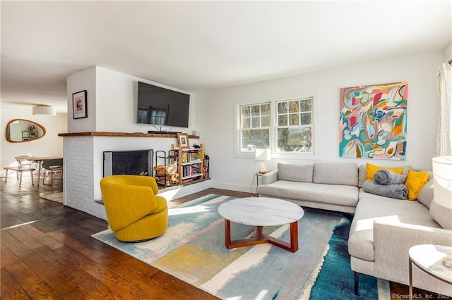 living room with a fireplace and dark hardwood / wood-style floors