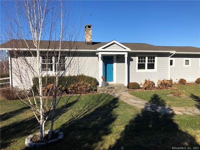 ranch-style house with a front lawn