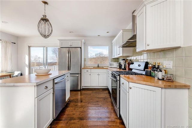 kitchen featuring white cabinetry, stainless steel appliances, and pendant lighting