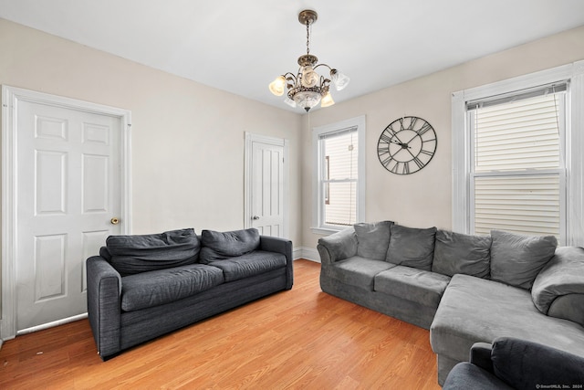 living room with hardwood / wood-style floors and a chandelier