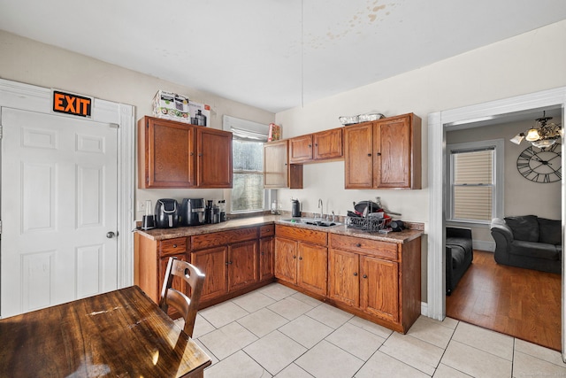 kitchen featuring light wood-type flooring, ceiling fan, and sink