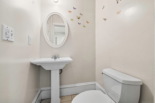 bathroom with tile patterned flooring and toilet