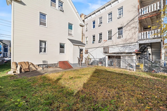 back of house with a yard and central AC