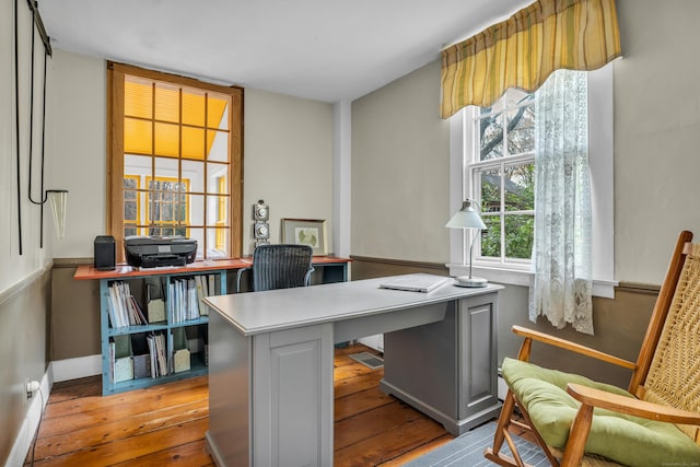 office space featuring baseboards and wood-type flooring