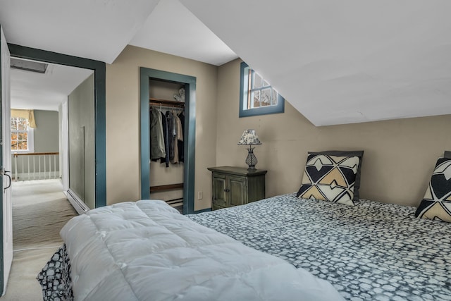 bedroom featuring carpet floors, a closet, baseboard heating, and visible vents