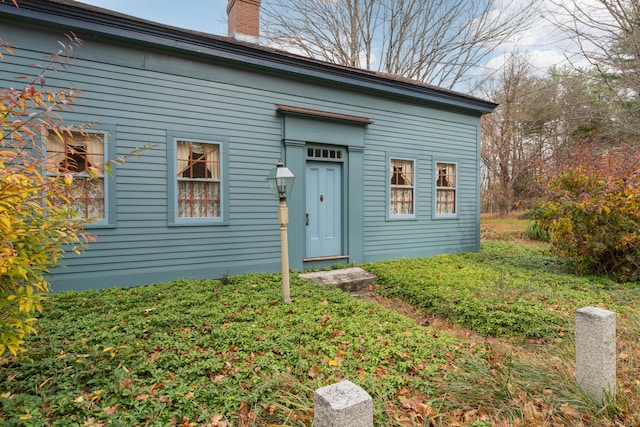 view of front facade with a chimney